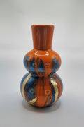 Decorative ceramic item with orange, blue, and gold patterns on a white background